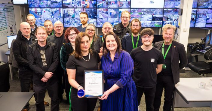 Alison Hernandez presents Megan Ward with a Commissioner's award, with CCTV operators in the background