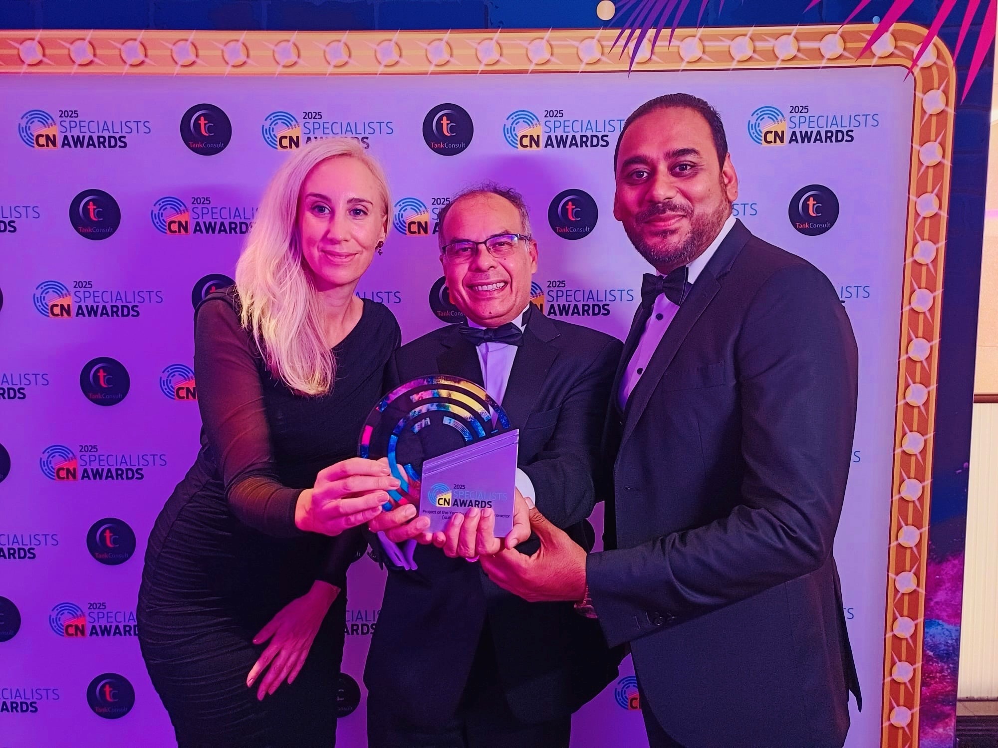 Elizabeth Record, Assistant Project Development Manager for Prisoners Building Homes, Debansu Das, Business Development Director ZED PODS and Lalit Chauhan, FCIAT Design Director at ZED PODS pictured holding the award at the gala evening