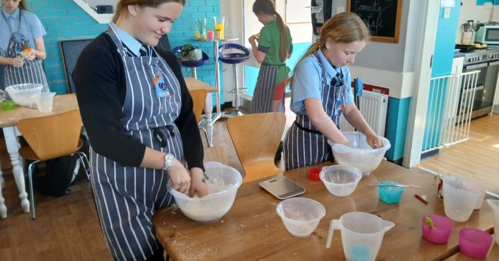 Recent recipients of the community grant scheme - young girls cooking