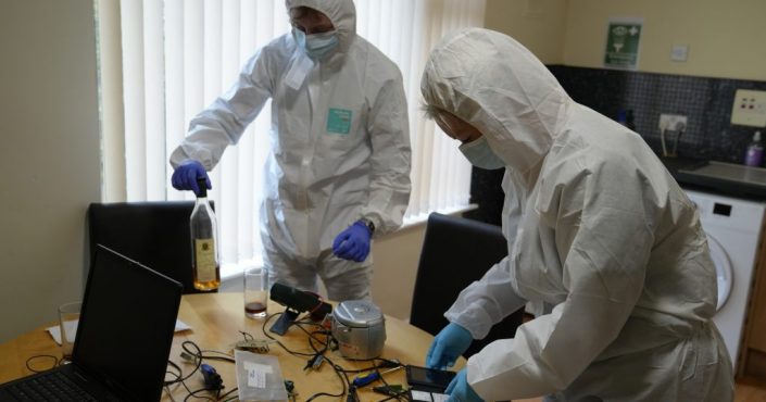 Students examining evidence at the 'crime scene' house