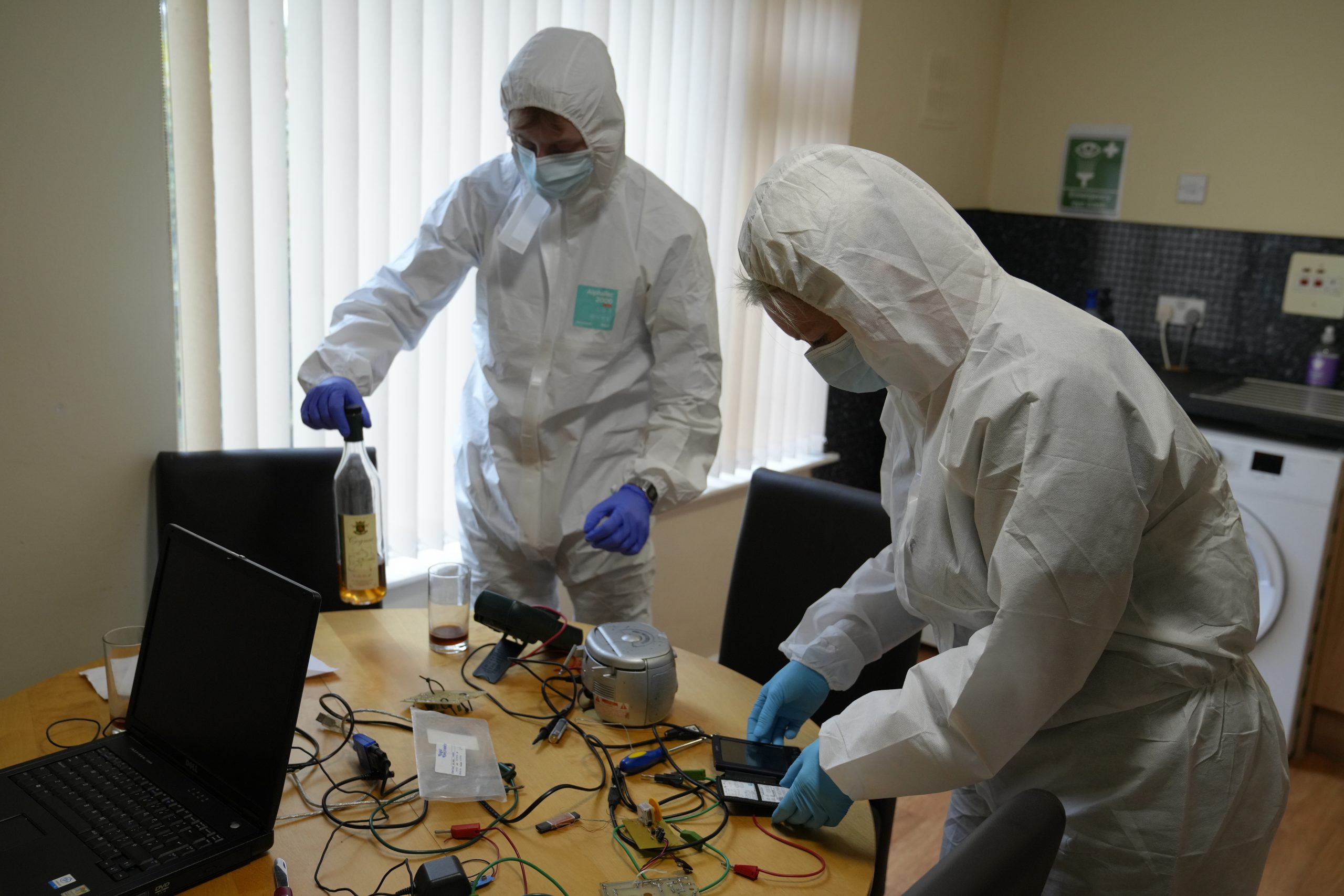 Students examining evidence at the 'crime scene' house
