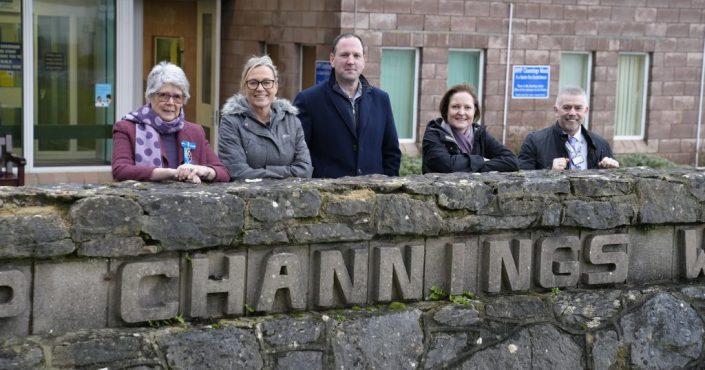 L-R, Caroline Harlow, High Sheriff of Devon; Lisa Richardson, HMP Channings Wood Reducing Reoffending and Family Pathway Lead; Andy Gallie, recovering gambling addict; Alison Hernandez, Police and Crime Commissioner and David Crawford, HMP Channings Wood Deputy Governor stood behind the prison brick wall sign